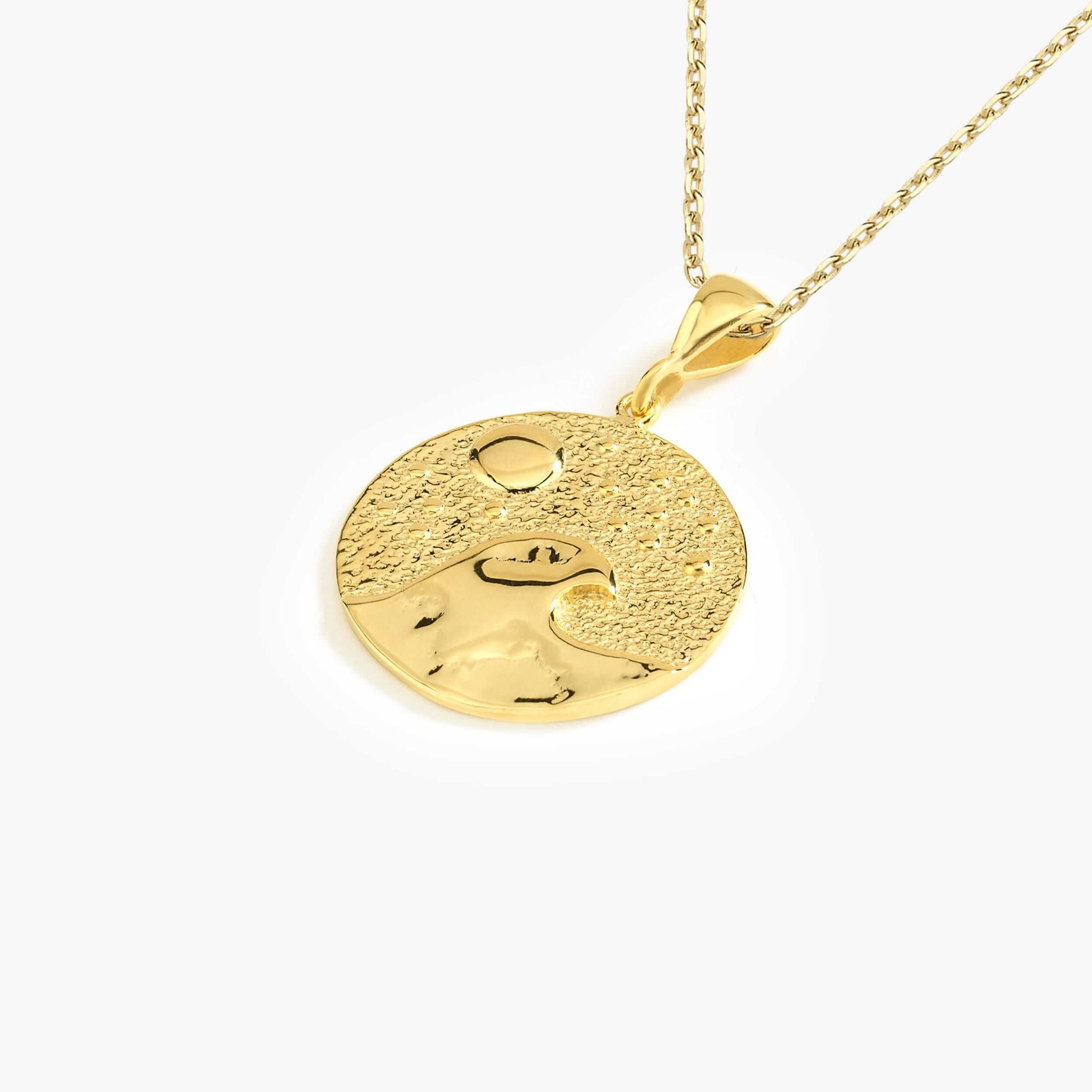 Gold pendant necklace featuring a wave and sun design, elegant jewelry for ocean lovers.
