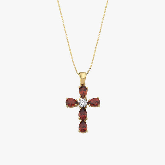 Gold necklace with cross pendant featuring red gemstones and central diamond on a delicate chain.