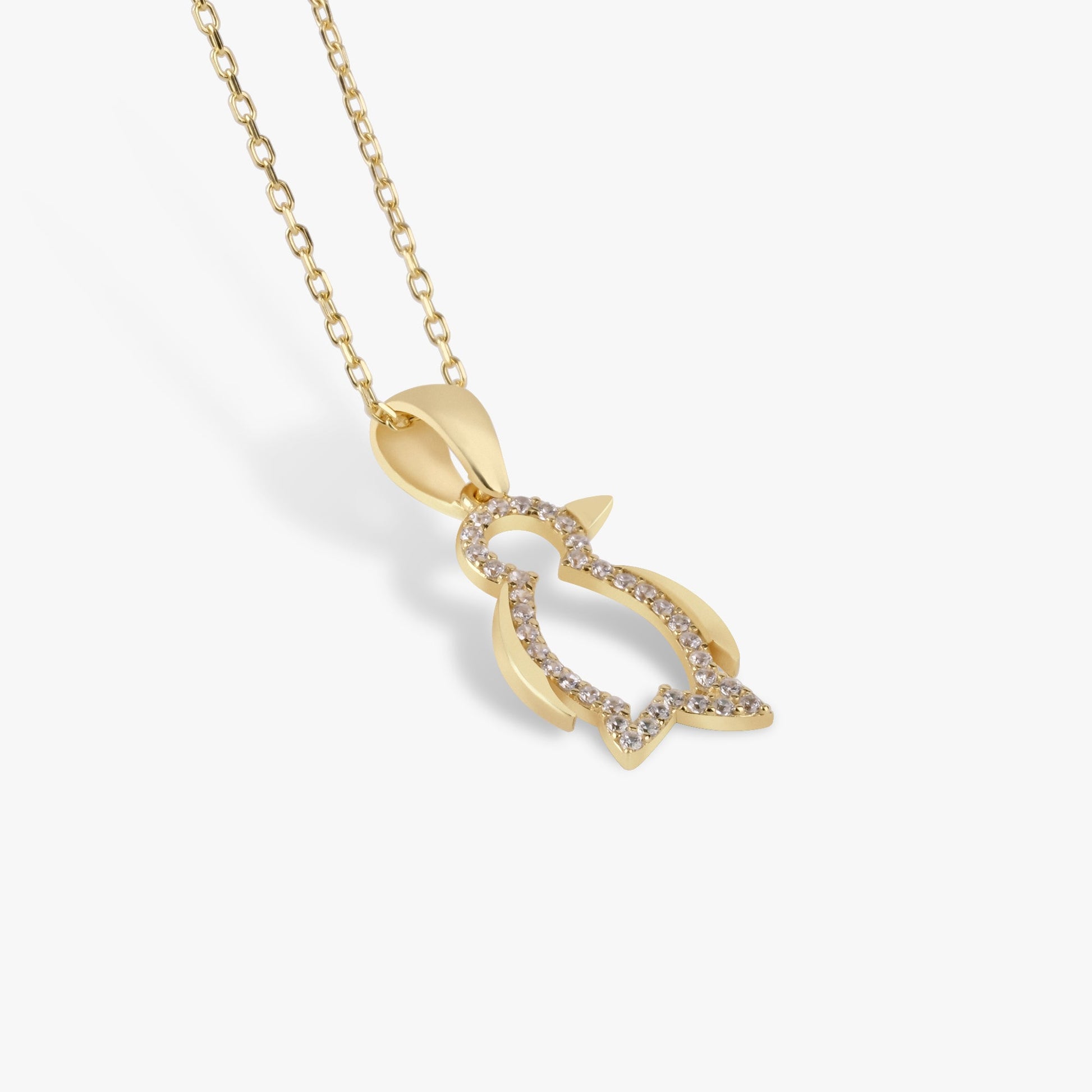 Gold penguin pendant necklace with diamond accents on a delicate chain, perfect for elegant jewelry lovers.