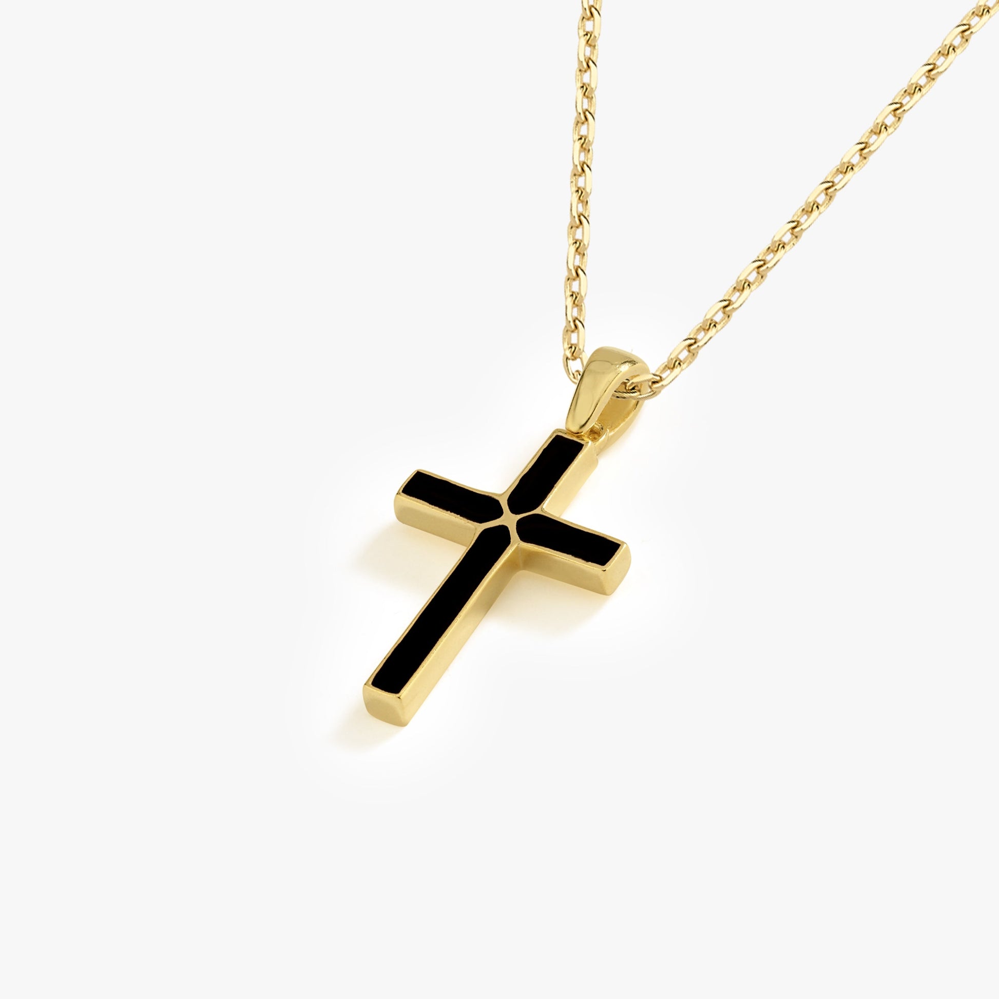 Gold chain with elegant black enamel cross pendant on a white background. Perfect for a stylish accessory.