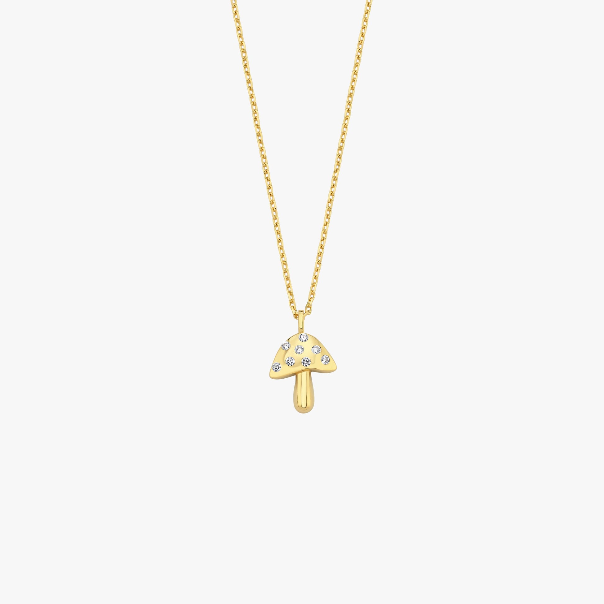 Gold mushroom pendant necklace with sparkling gemstones on a delicate chain, perfect for elegant fashion styling.