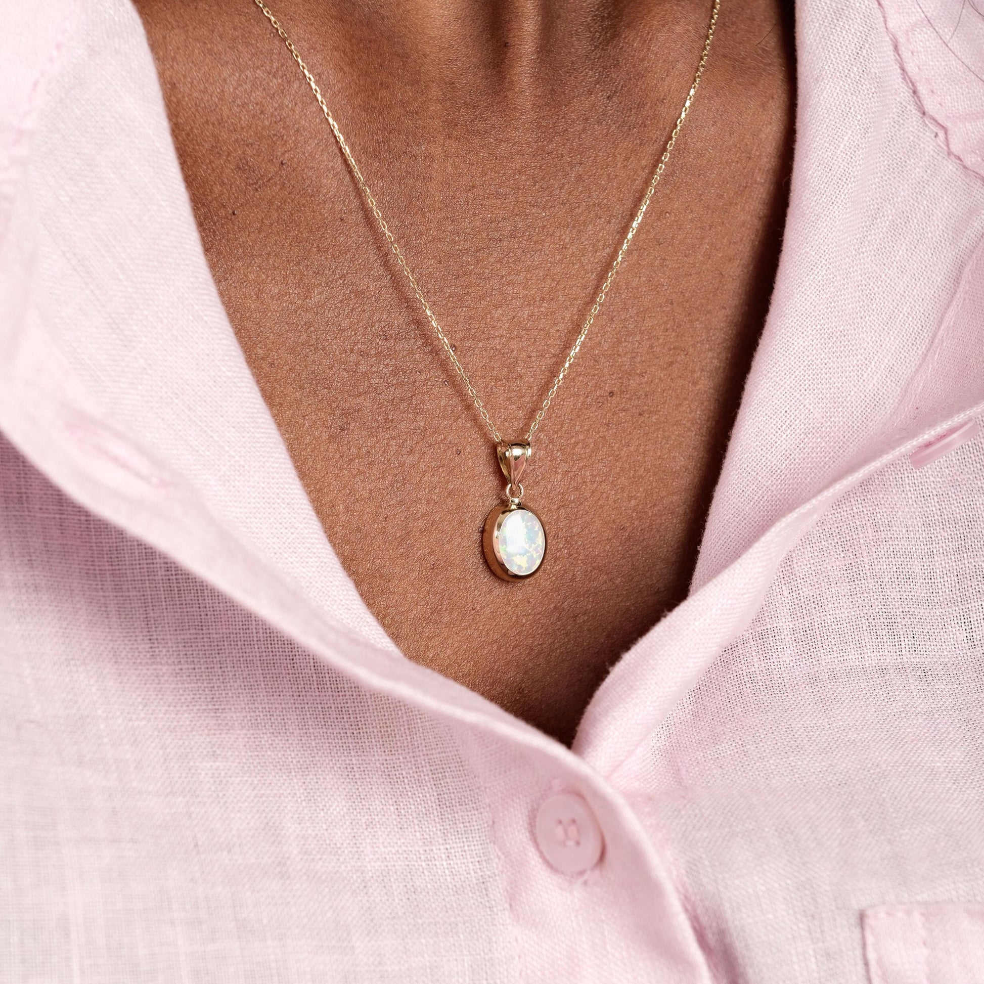 A detailed side view of the 14K Solid Gold White Opal Necklace reveals the opal’s depth and subtle color variations.