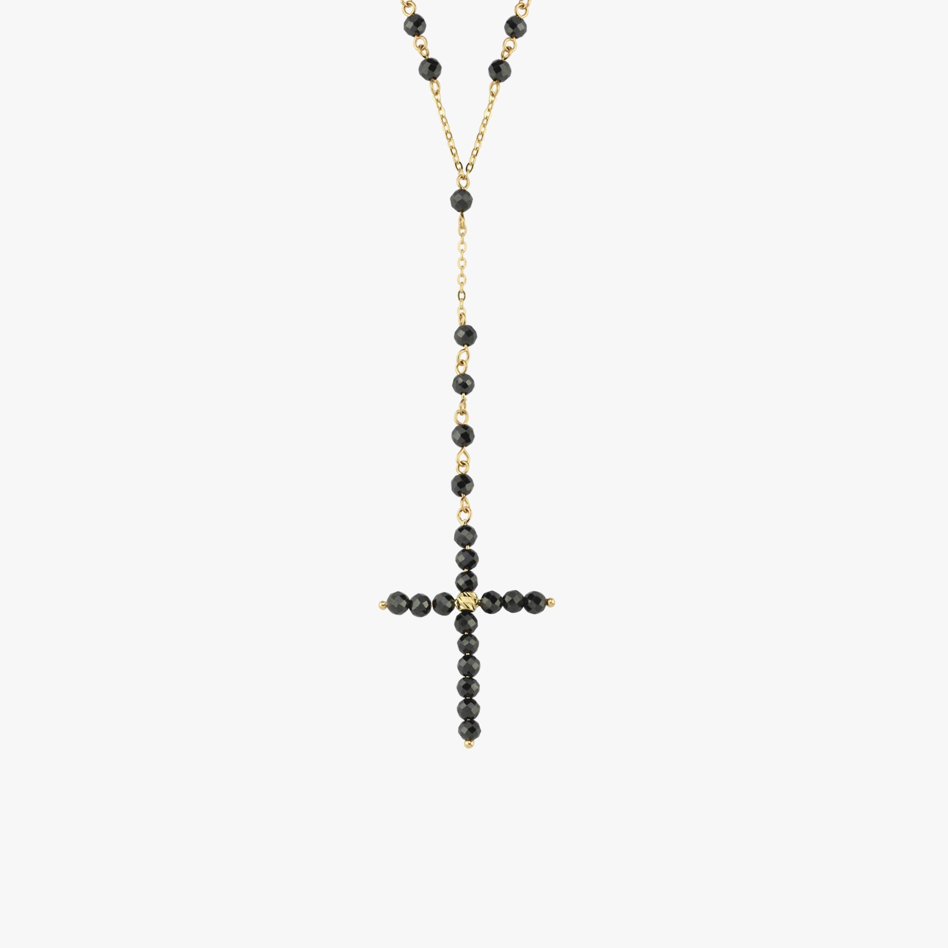 A onyx rosary necklace laid flat, showcasing its gold chain, bead details, and cross charm.