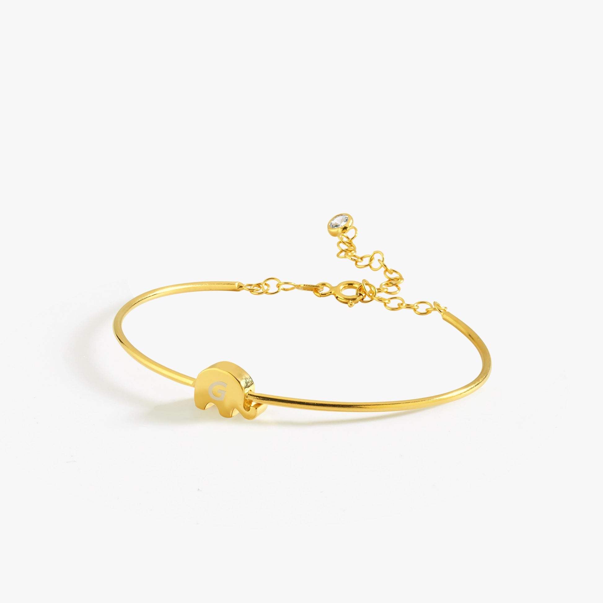 A stylish and elegant gold bangle bracelet paired with a pink blouse.