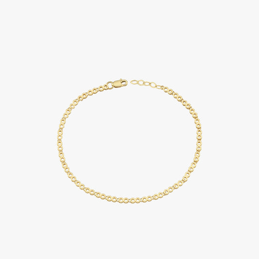 A 14K gold chain bracelet laid flat on a white background, emphasizing its intricate links.