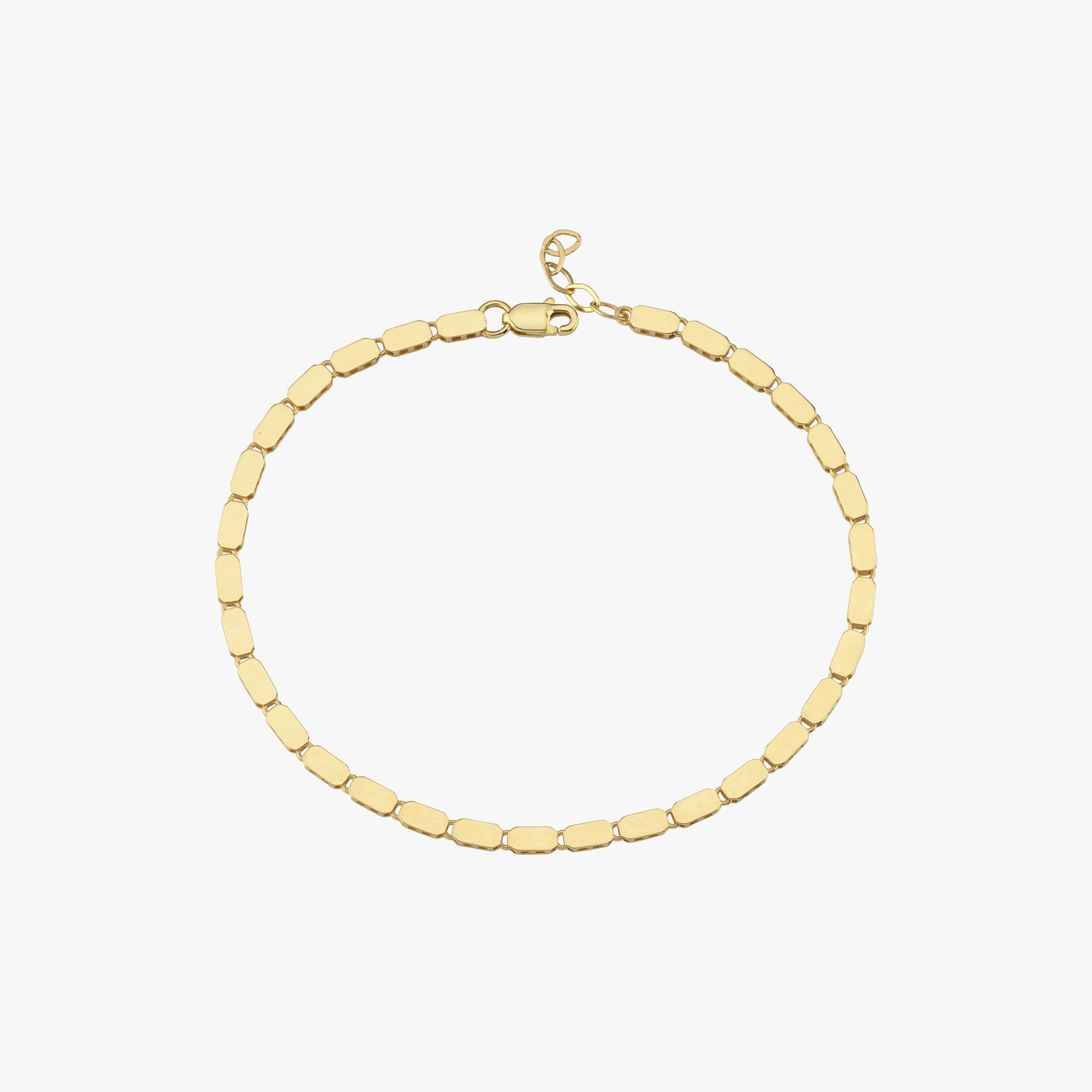 A side profile of a model wearing a 14K gold mirror chain bracelet, reflecting subtle golden hues.