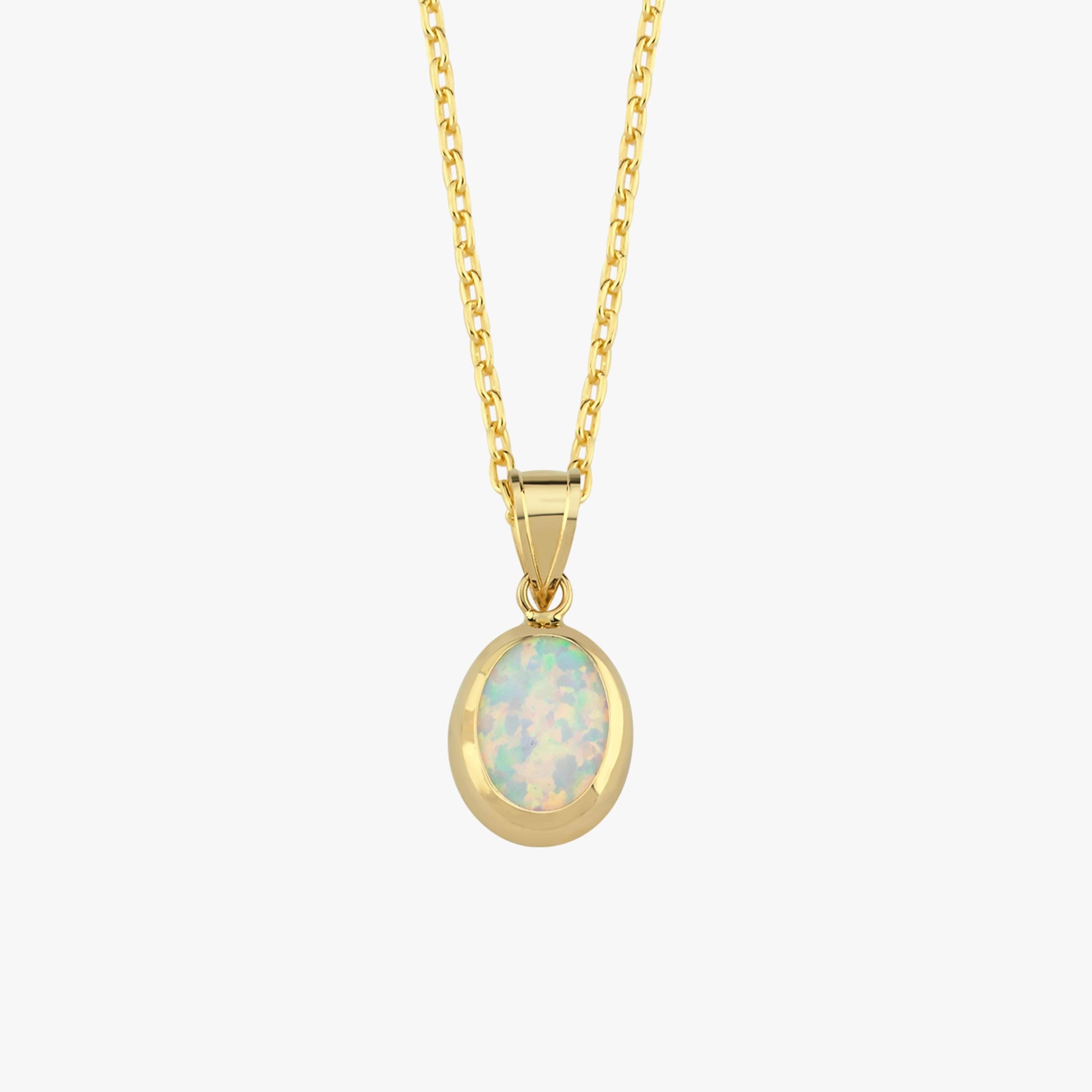 A close-up of the 14K Solid Gold White Opal Necklace showcases the iridescent opal stone set in a smooth gold bezel.