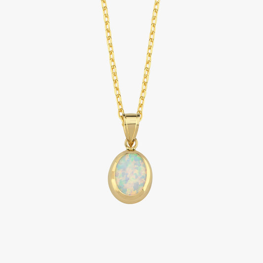 A close-up of the 14K Solid Gold White Opal Necklace showcases the iridescent opal stone set in a smooth gold bezel.