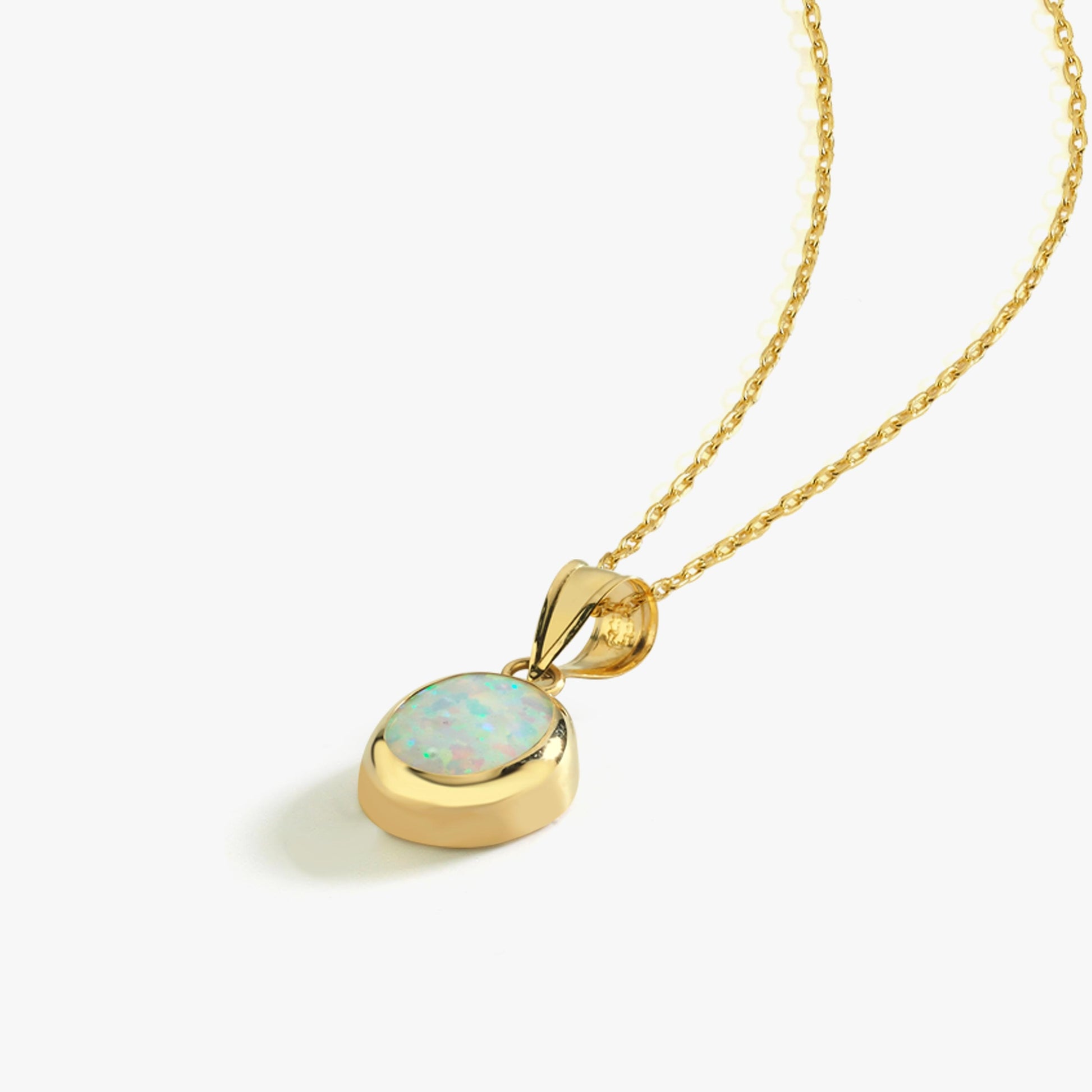 The 14K Solid Gold White Opal Necklace is displayed against a white background, highlighting its fine gold chain and shimmering opal charm.