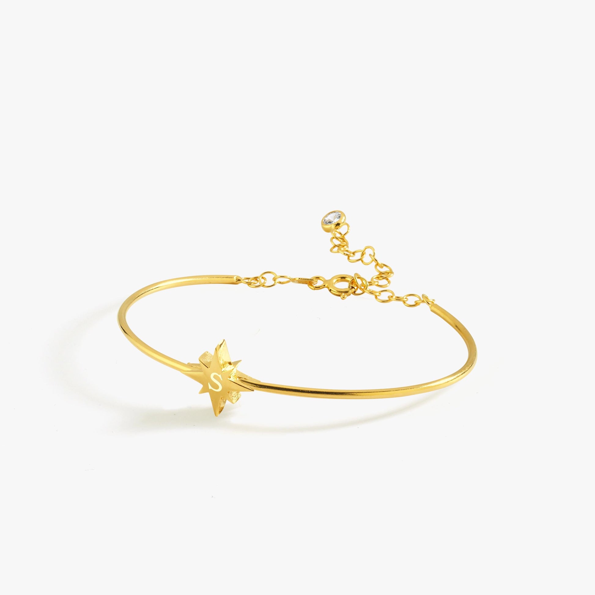 The 18K Gold Vermeil Initial Cuff Bracelet showcases a dainty engraved initial on a celestial-inspired star.