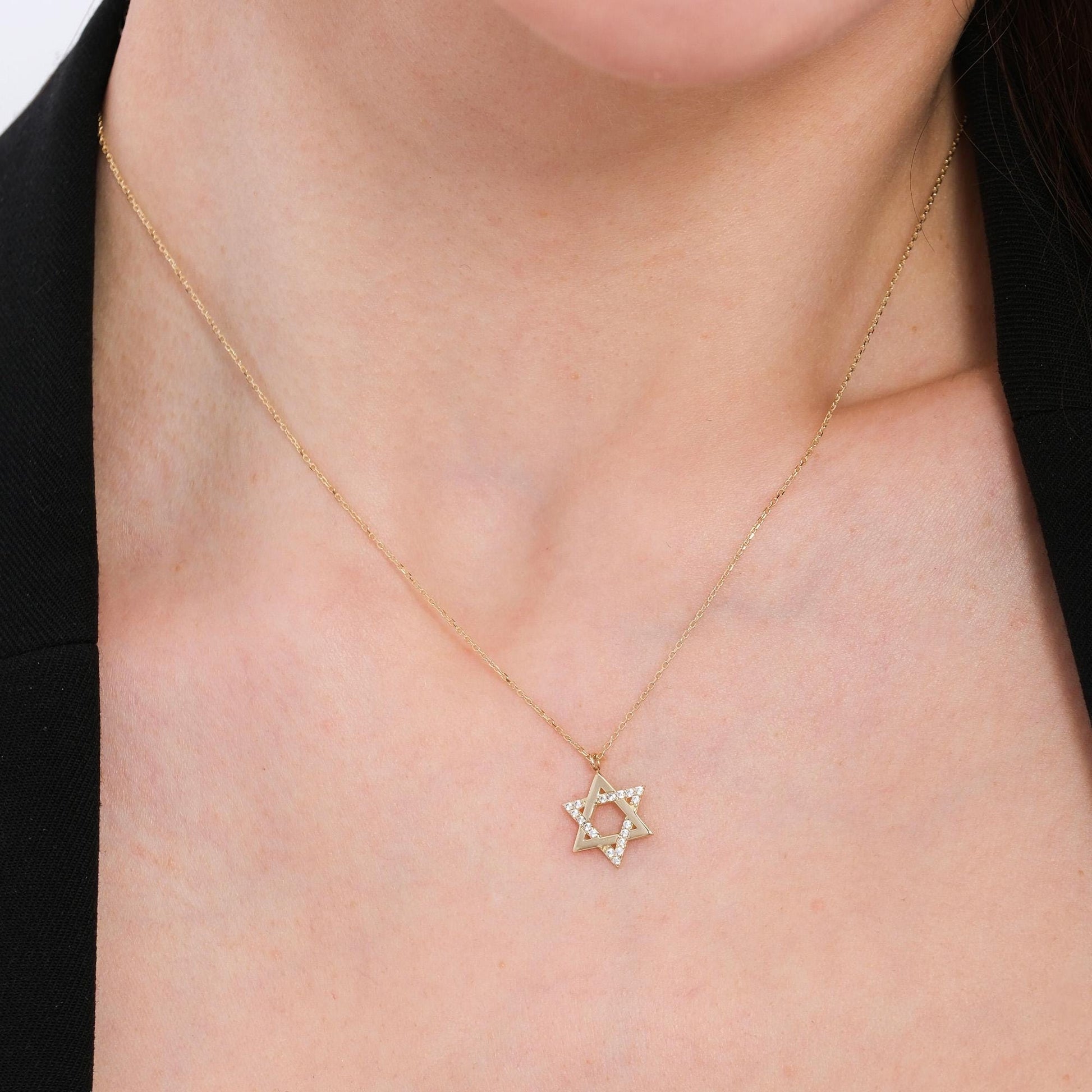 4K solid gold Star of David necklace on a bare neckline, highlighting the pendant's clean lines and subtle sparkle.