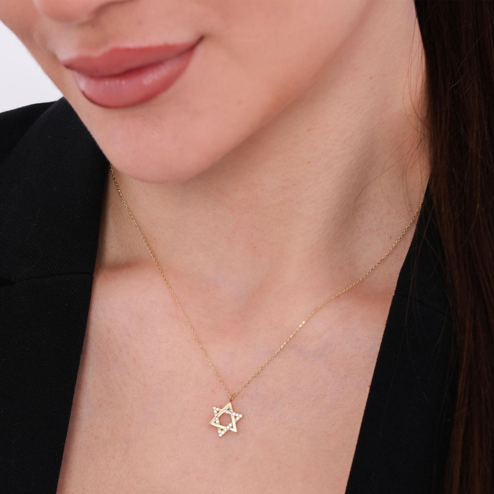 Model wearing a 14K solid gold Star of David necklace, featuring a delicate diamond-studded design on a minimalist chain.
