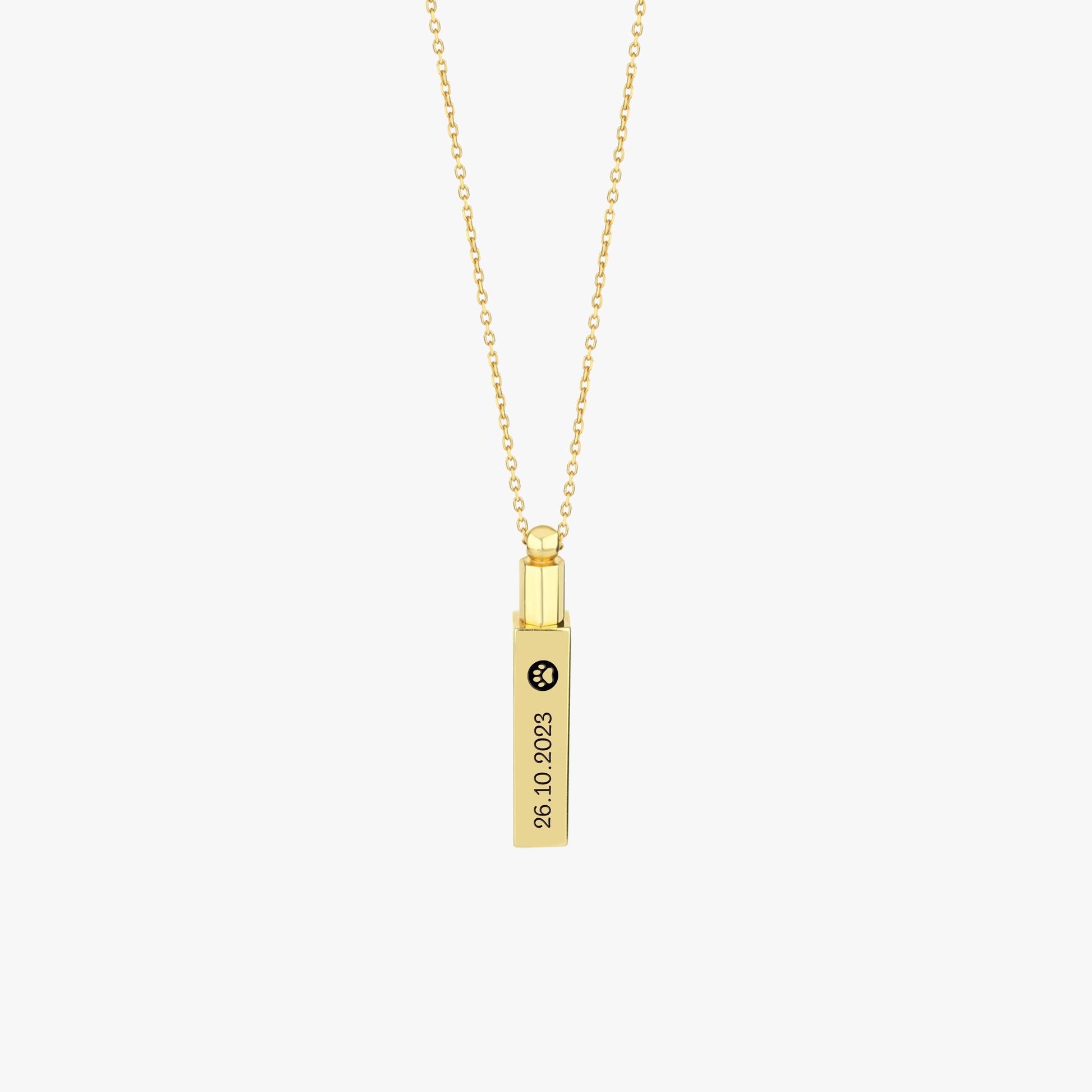 Close-up of 14K gold plated personalized cremation urn necklace with vertical engraving.