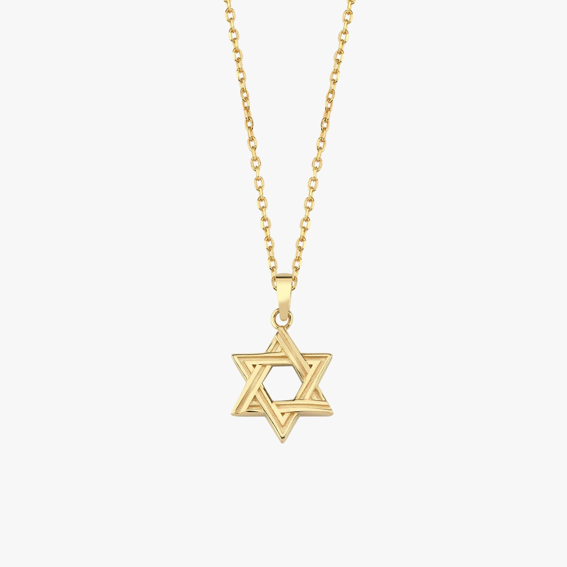 Close-up of 14K Solid Gold Magen David Necklace on collarbone.