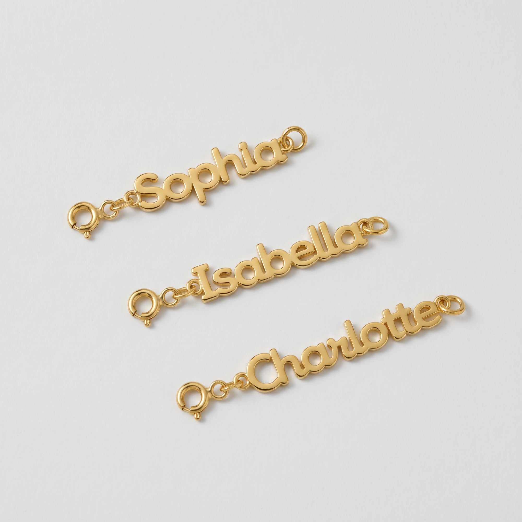 Personalized gold name tag necklace extenders engraved with Sophia, Isabella and Charlotte