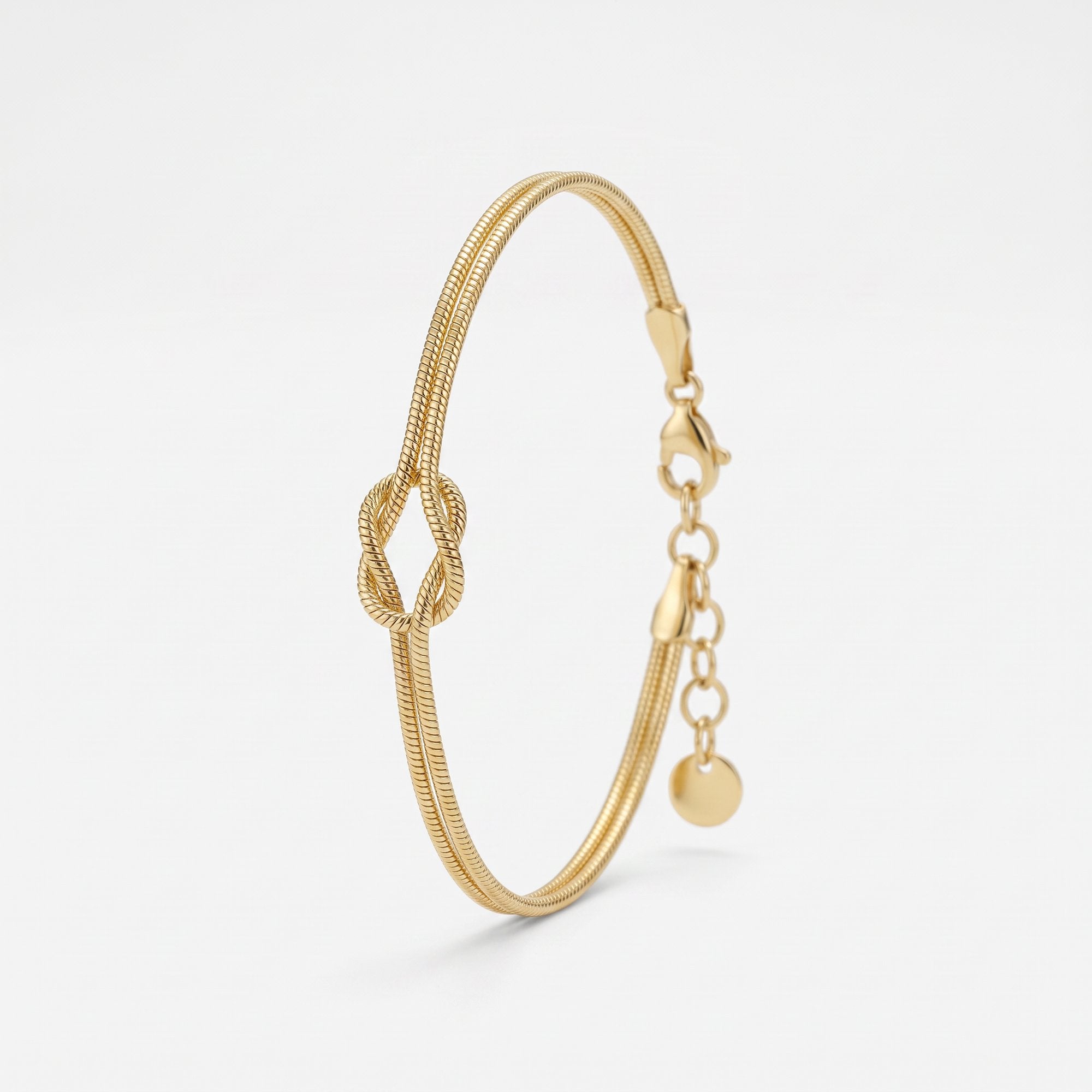 Gold love knot bracelet in 14K gold vermeil, a double snake chain tied in a knot, with lobster clasp and extender
