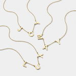 Gold 3 initial necklaces with spaced letter charms on fine chains