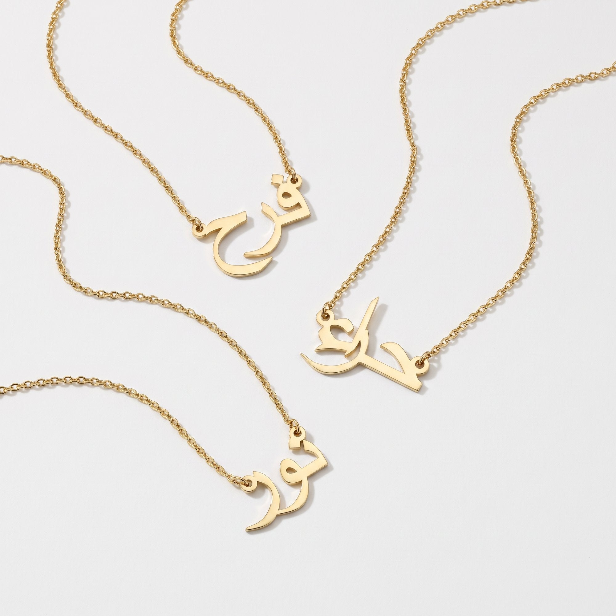 Gold Arabic name necklaces in custom calligraphy