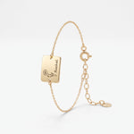 Gold birth flower bracelet with a square plate engraved with a birth flower and name, a personalized birth flower bracelet in 14K solid gold