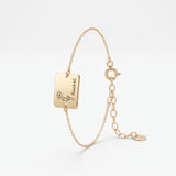 Gold birth flower bracelet with a square plate engraved with a birth flower and name, a personalized birth flower bracelet in 14K solid gold