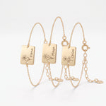 Custom gold birth flower bracelets with engraved name tag charms