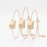 Custom gold birth flower bracelets with engraved name tag charms