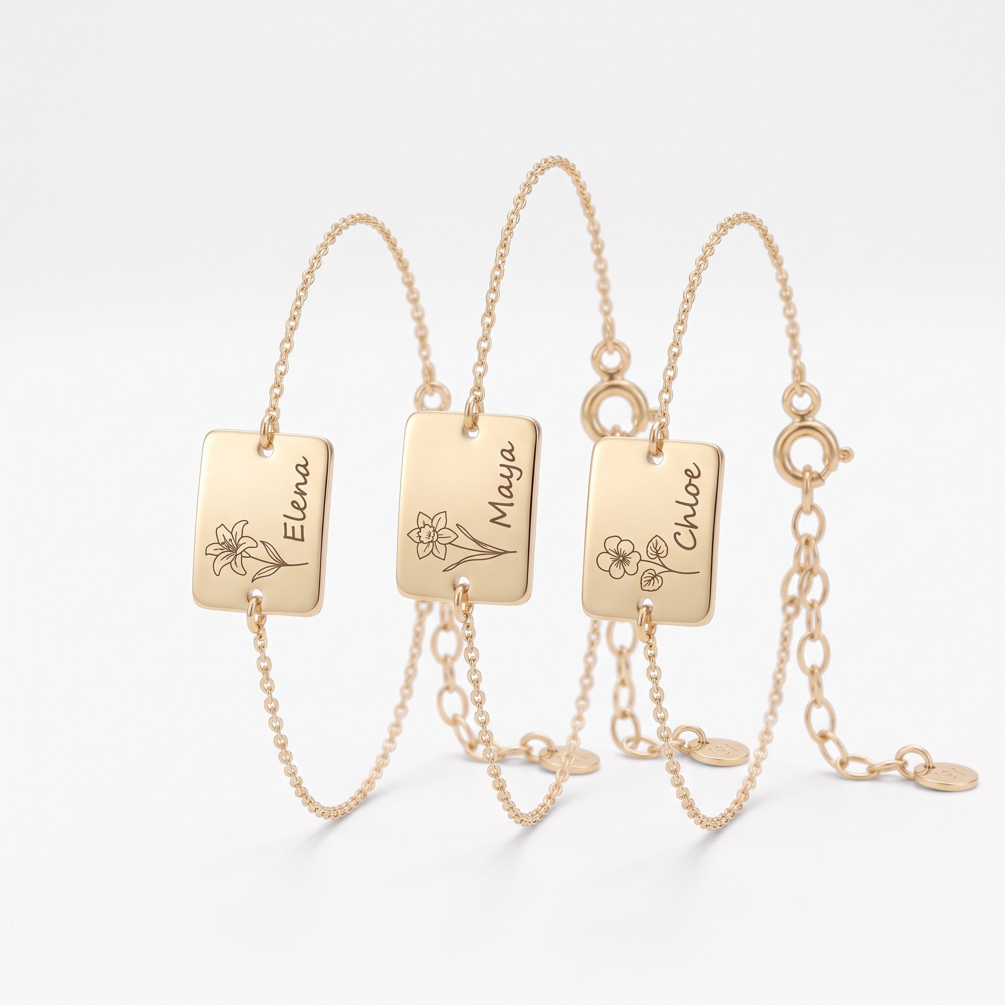 Custom gold birth flower bracelets with engraved name tag charms