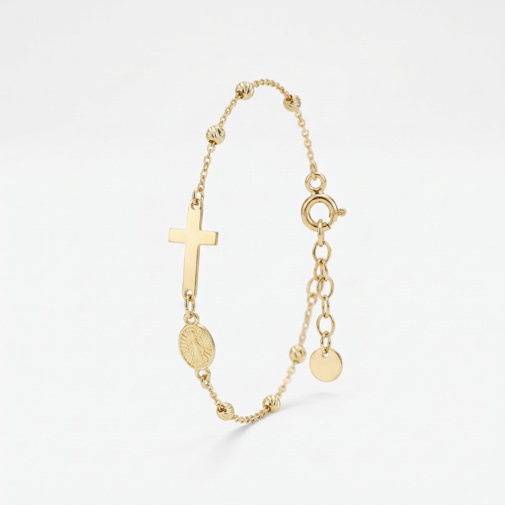 Gold rosary bracelet with a sideways cross and Miraculous Medal of Mary between gold beads, with extender chain