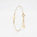 Gold sideways cross bracelet with a polished cross on a dainty cable chain, with spring ring clasp and extender