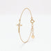 Tiny gold cross bracelet for women with five cubic zirconia stones at the center, a dainty chain bracelet with extender
