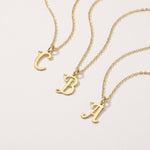Gold cursive initial necklaces with A, B and C letter pendants