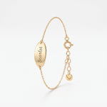 Custom engraved bracelet in 14K solid gold, an oval disc personalized with a name in script on a dainty chain