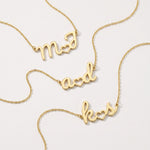 Gold custom initial necklaces with two initials joined by a heart