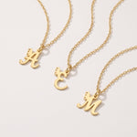 Gold custom letter necklaces with a butterfly on the initial pendant
