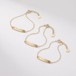 Gold custom name bracelets with engraved bar plates