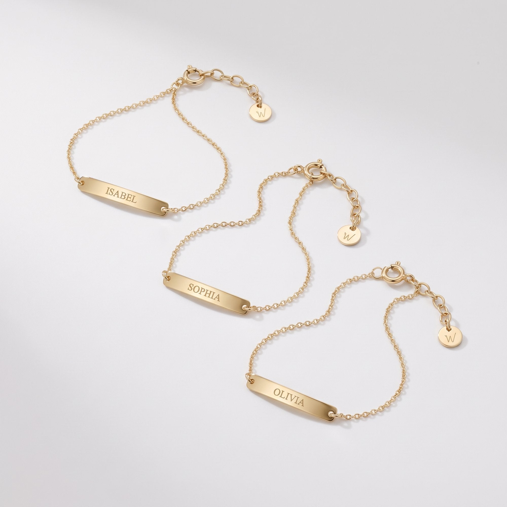 Gold custom name bracelets with engraved bar plates