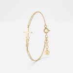 Gold name bracelet with a sideways cross and custom script name, a personalized baptism bracelet on a double cable chain