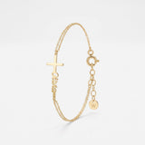 Gold name bracelet with a sideways cross and custom script name, a personalized baptism bracelet on a double cable chain