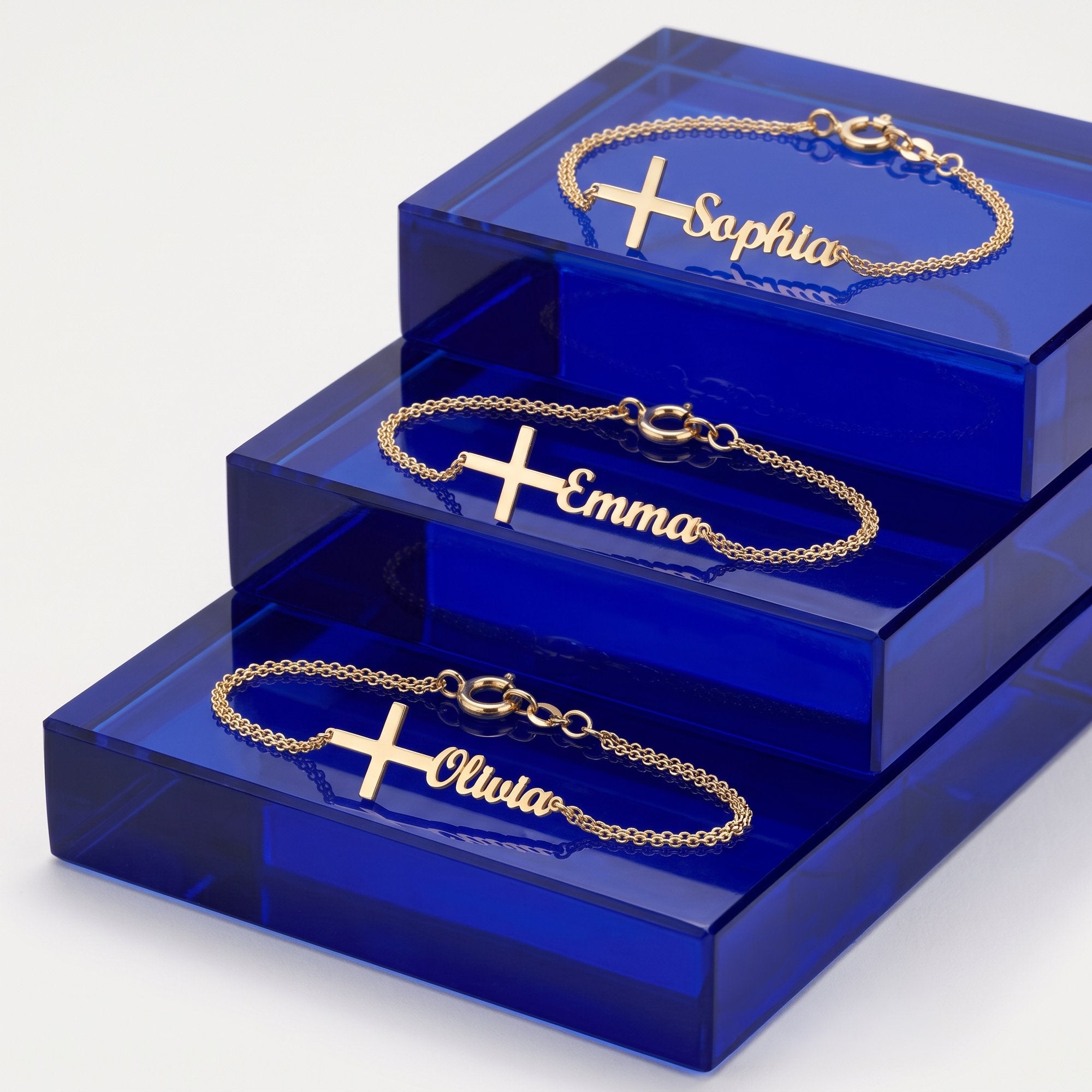 Gold cross name bracelets with Sophia, Emma and Olivia in script