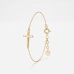 Dainty gold cross bracelet with a rounded sideways cross on a fine cable chain, with spring ring clasp and extender