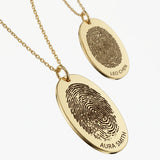 Custom gold fingerprint necklaces with engraved oval pendants and names