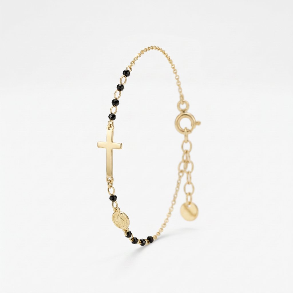Gold rosary bracelet with black onyx beads, a sideways cross and Miraculous Medal on a dainty chain with extender