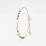 Gold rosary bracelet with black onyx beads, a sideways cross and Miraculous Medal on a dainty chain with extender