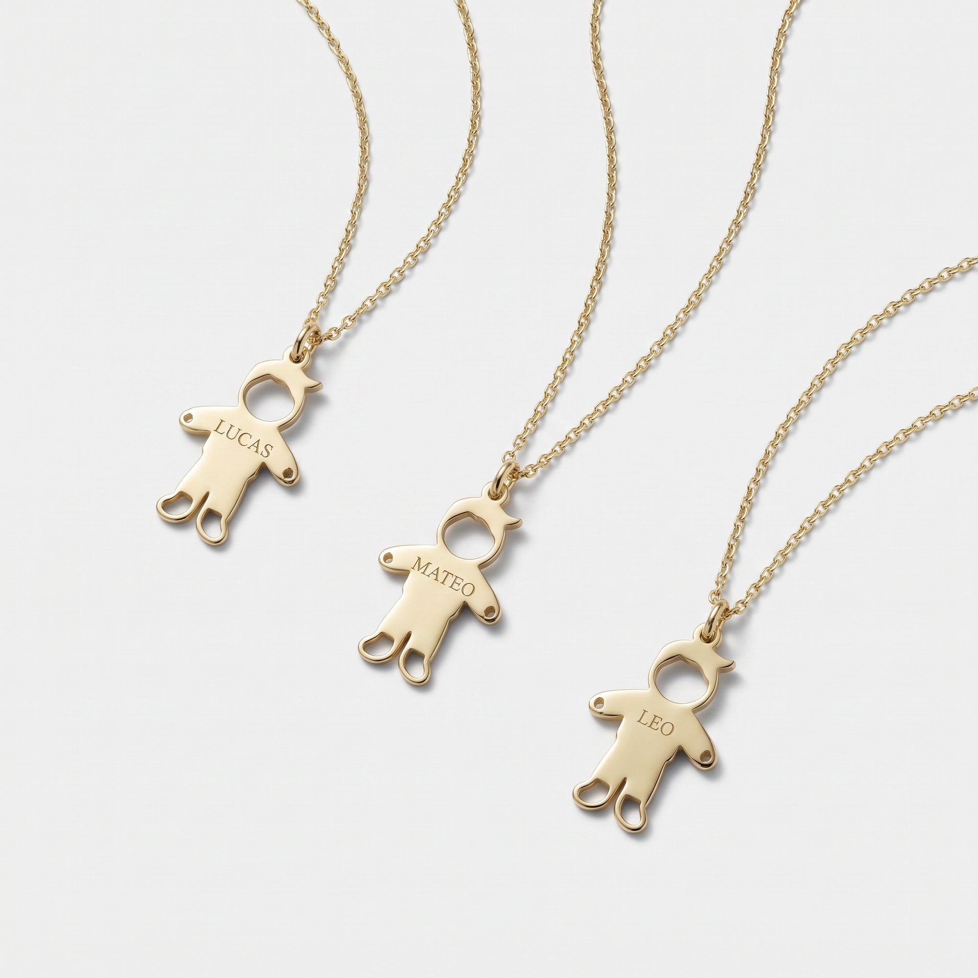 Personalized gold family necklaces with engraved boy charms named Lucas, Mateo and Leo