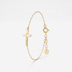 Gold sideways cross bracelet with a cut-out center cross on a dainty cable chain, a Christian cross bracelet with extender