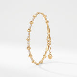 Gold bone bracelet with bone shaped links and cubic zirconia bars, a skeleton chain bracelet in 18K gold vermeil