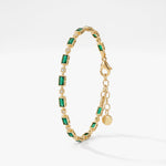 Emerald tennis bracelet in 18K gold vermeil with bezel-set emerald green baguette stones and small clear stones, with extender