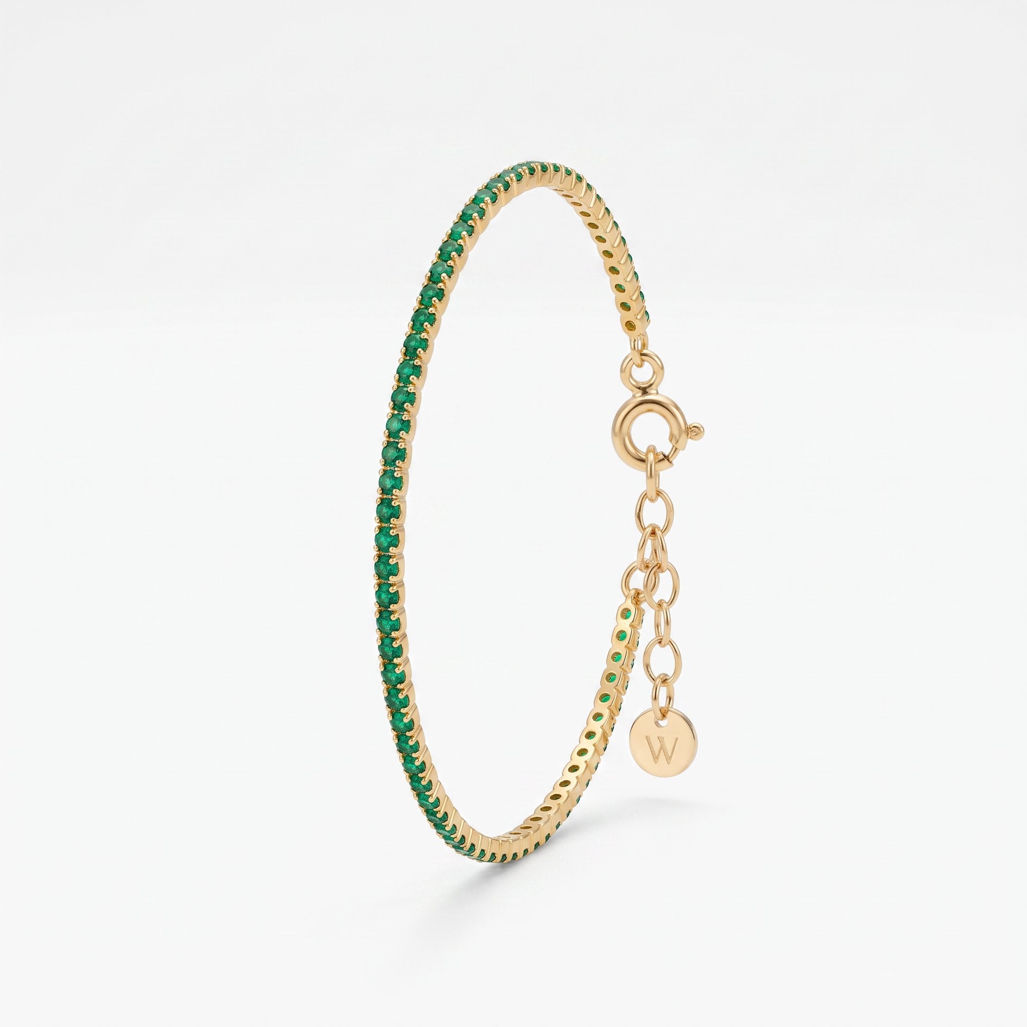 Dainty emerald tennis bracelet in 18K gold vermeil, a row of round green stones in prong settings with extender chain