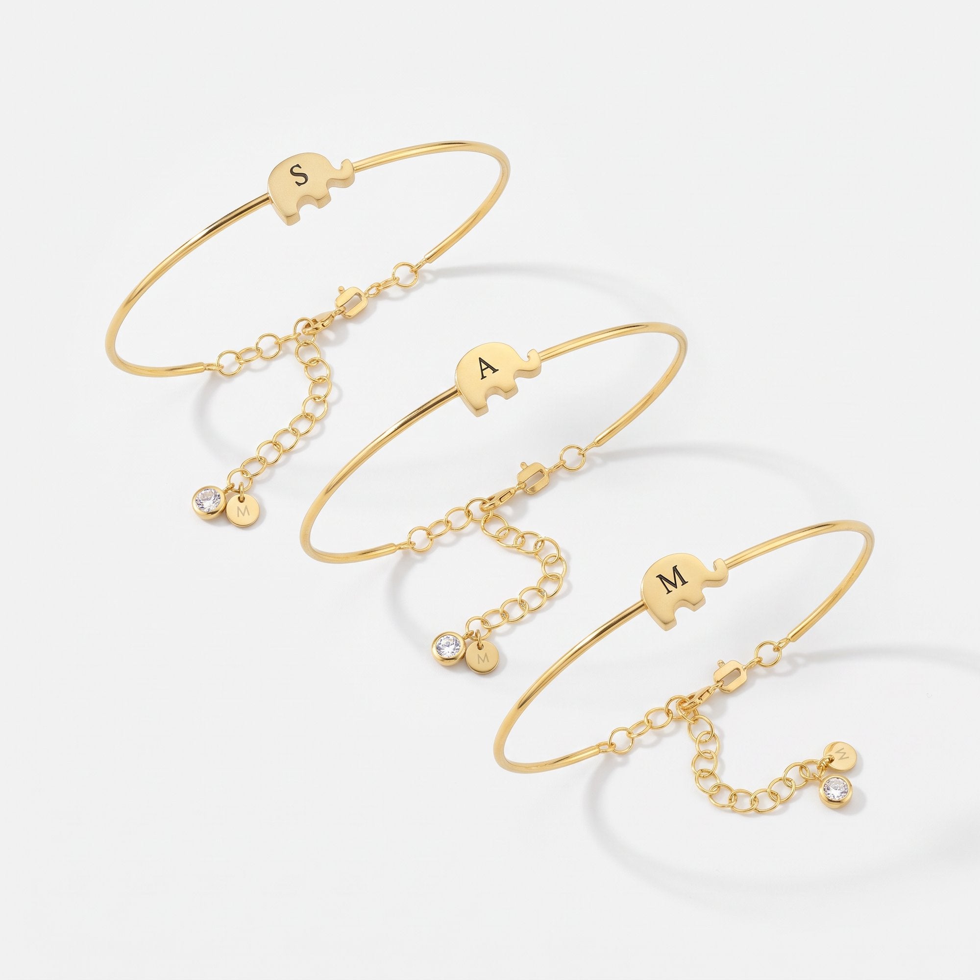 Gold elephant bangle bracelets with custom initials and birthstone charms