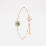Gold turtle bracelet with a colorful enamel sea turtle charm, double-sided with an evil eye on the back, on a dainty chain